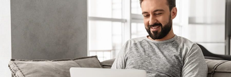 Man checking his credit score on the couch from home | Financial Information | Tiger Finance