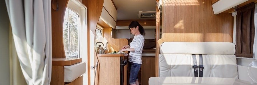 Woman cooking in her new caravan | Financial Information | Tiger Finance